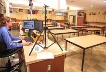 Science teacher Geoff Reilly teaches an online class from his empty classroom