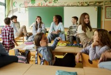 Middle school students talking in classroom