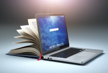 A computer and book indicating new challenges in digital learning.